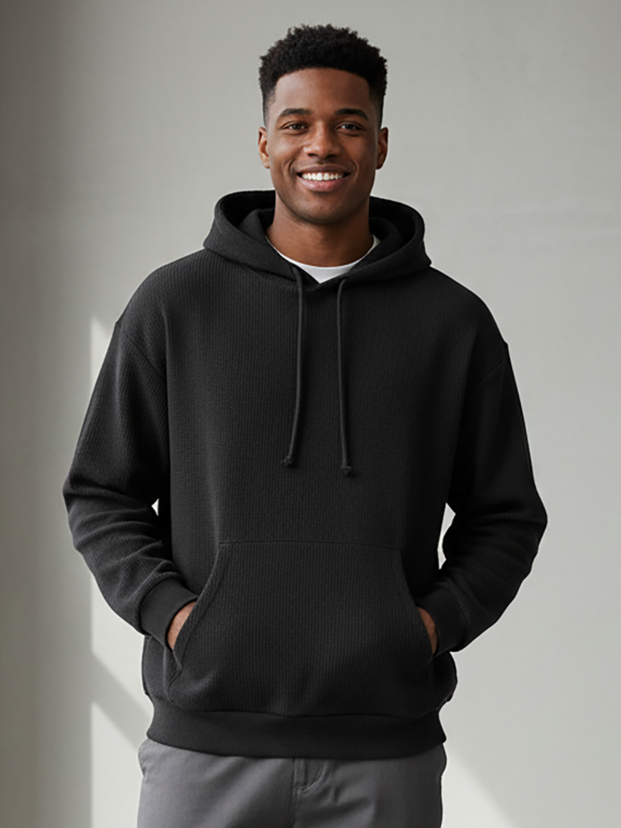 Unisex Corded Pullover Hoodie in Black – model front