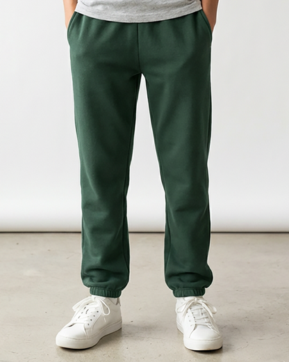 Kids' Core Fleece Pant in Dark Green – model front