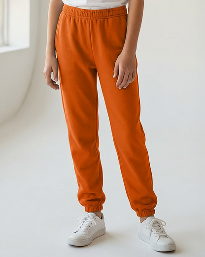 Kids' Core Fleece Pant in Orange – model front